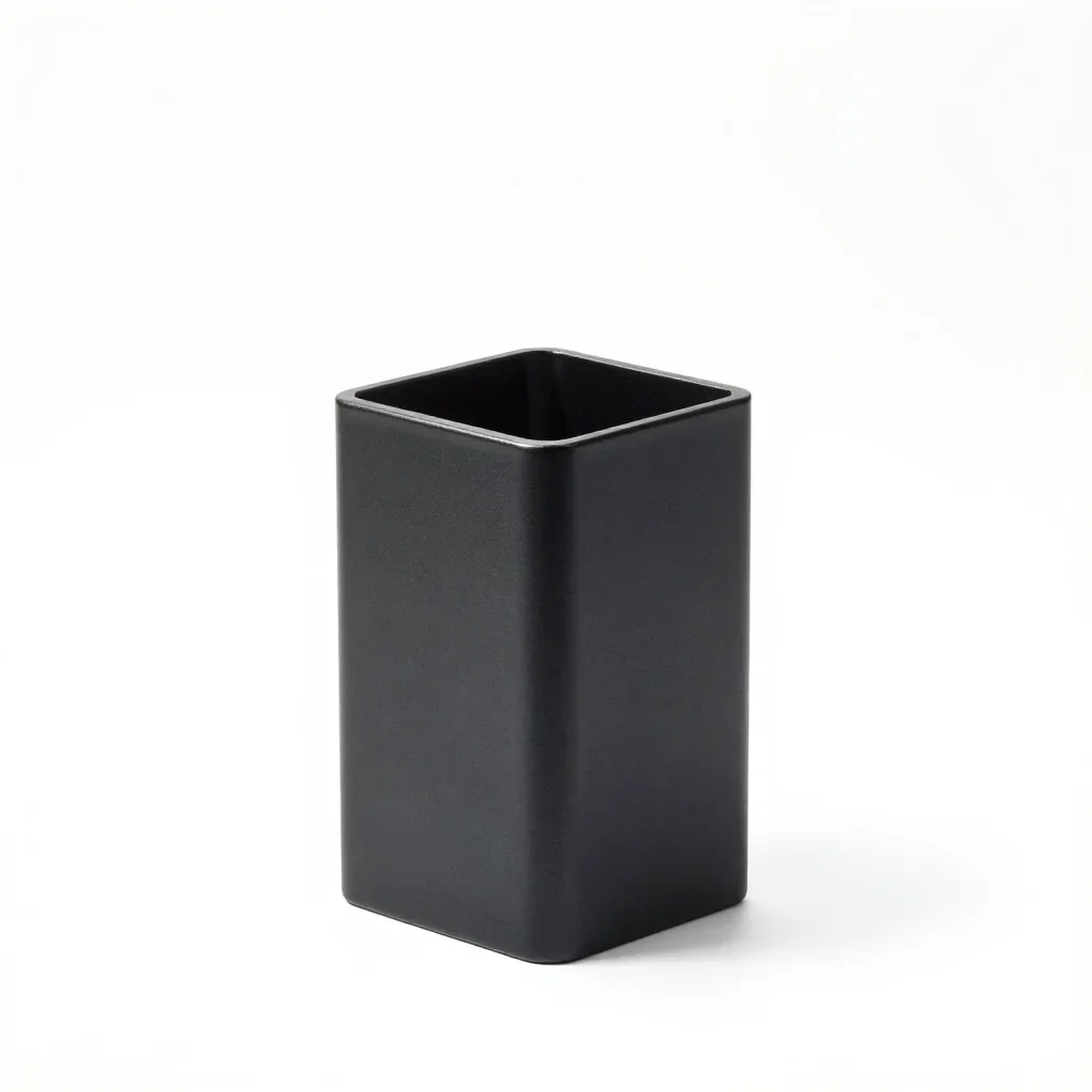 Matte black toothbrush holder isolated on a white background