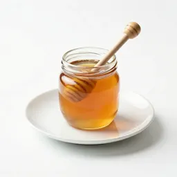 Jar of honey with a dipper