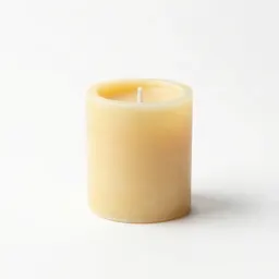 Beeswax pillar candle on a holder