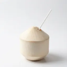 Fresh coconut with a straw