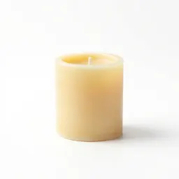 Beeswax pillar candle on a holder
