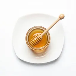Jar of honey with a dipper