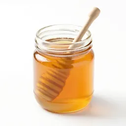 Jar of honey with a dipper