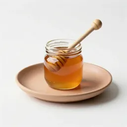 Jar of honey with a dipper