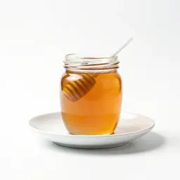 Jar of honey with a dipper