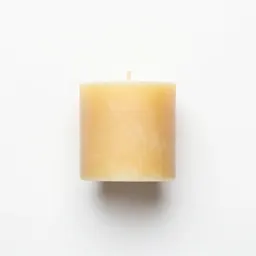 Beeswax pillar candle on a holder