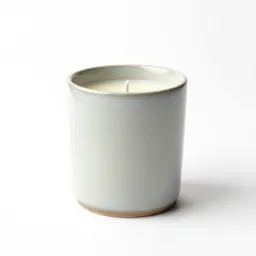 Beeswax pillar candle on a holder