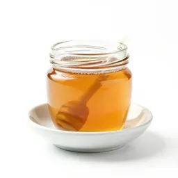 Jar of honey with a dipper
