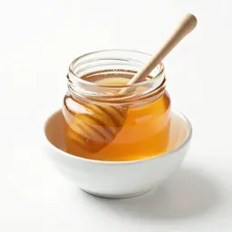 Jar of honey with a dipper