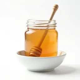 Jar of honey with a dipper