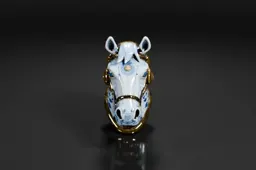 Close-up of a small figurine of a horse's head
