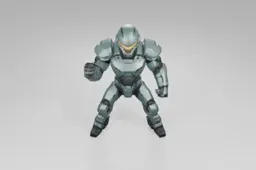 Futuristic armored figure stands confidently, wearing a green exosuit with a
