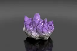 Cluster of amethyst crystals on a black surface