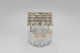 Stone water well with a wooden roof, pulley system, and bucket perched on the