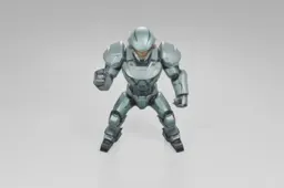 Futuristic armored figure stands confidently, wearing a green exosuit with a