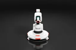 Small robot-like object with a white body and red accents