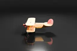 Small vintage biplane with a yellow and cream body, red propeller, and round
