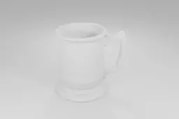 White ceramic mug with a handle on one side and a spout on the other