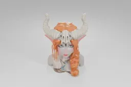 Small figurine of a woman with long orange hair and blue eyes