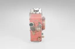 Small, red-colored mechanical device with a cylindrical shape
