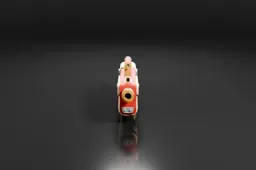Small red and gold-colored object on a black background