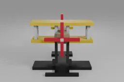 Small yellow and beige biplane with a red propeller and tail fin sits on a