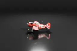 Red toy airplane on a black background