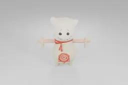 Small fabric doll with a stitched smile, button eyes, red scarf, and wooden