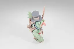 Figurine of a green monster with a top hat and a cane