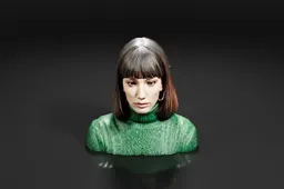 Portrait of a young woman with shoulder-length dark hair and bangs