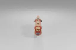 Stylized toy blaster features a chunky red and beige body with playful