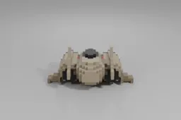 Small, sleek, beige spaceship with rounded edges and a dark cockpit sits on a