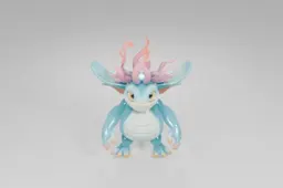 Playful cartoon dragon-like creature with turquoise scales, a cream-colored