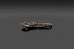 Cast-iron antique skeleton key with an ornate scrollwork bow and worn patina