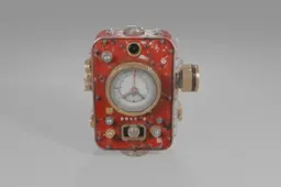 Red, weathered mechanical device featuring a large central gauge, brass