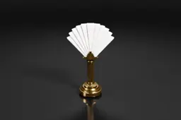 Small, ornate lamp with a golden base and a white fan-like structure on top