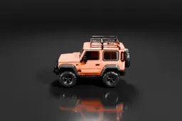 Compact orange off-road vehicle with large rugged tires, a black roof rack